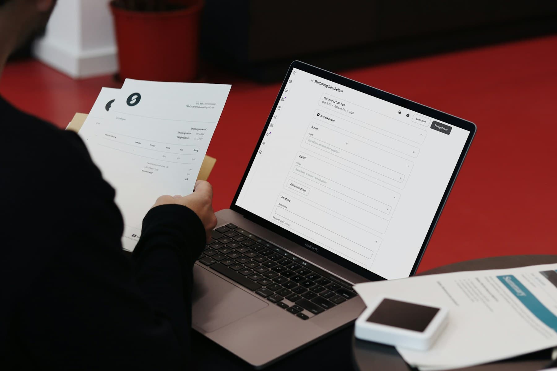 Independent contractor reviewing an invoice beside a laptop